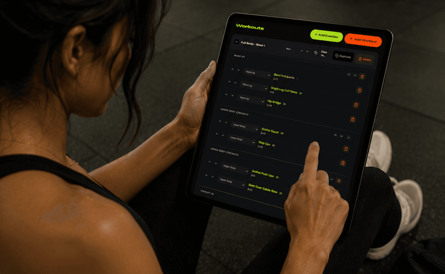 Personal trainer programming and coaching a client workout in the Dialed Fitness app